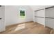 Bedroom with closet, wood floor, bright light from window with view of green outdoors at 2339 Eastwood Dr, Snellville, GA 30078