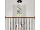 Hallway features wood railings, metal spindles, and a chandelier at 2339 Eastwood Dr, Snellville, GA 30078