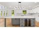 Open kitchen boasts a large island and modern lighting fixtures at 2339 Eastwood Dr, Snellville, GA 30078