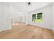 An open living area featuring hardwood floors, archways, and bright windows at 2339 Eastwood Dr, Snellville, GA 30078