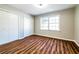 Bedroom with wood flooring, large window, and closet at 3626 Buford Ne Hwy # C2, Brookhaven, GA 30329