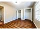 Bedroom with wood flooring, a window, and closet space at 3626 Buford Ne Hwy # C2, Brookhaven, GA 30329
