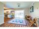 Bright dining area featuring modern kitchen view, wood-look floors, and sliding doors to the outside at 3626 Buford Ne Hwy # C2, Brookhaven, GA 30329