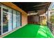 A brick patio with a covered roof, sliding glass doors, and artificial turf, offering a cozy outdoor space at 3626 Buford Ne Hwy # C2, Brookhaven, GA 30329