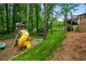 Play area with swing set and slide in grassy fenced backyard at 6119 Fairlong Nw Run, Acworth, GA 30101