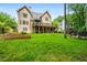 Large backyard with a spacious deck, lush lawn, and mature trees at 6119 Fairlong Nw Run, Acworth, GA 30101