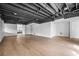 Spacious finished basement with wood-look floors and exposed ceiling at 6119 Fairlong Nw Run, Acworth, GA 30101