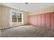 Bright bedroom with wainscoting accent wall and large window overlooking wooded area at 6119 Fairlong Nw Run, Acworth, GA 30101