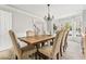 Elegant dining room featuring a wooden table, neutral chairs, and a decorative chandelier at 6119 Fairlong Nw Run, Acworth, GA 30101