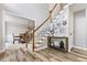 Inviting foyer with staircase, wood floors, and view into formal dining room at 6119 Fairlong Nw Run, Acworth, GA 30101
