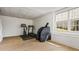 Home gym area featuring exercise equipment, wood flooring, and natural light at 6119 Fairlong Nw Run, Acworth, GA 30101