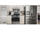 Kitchen featuring stainless steel appliances and white cabinetry with plenty of counter space at 6119 Fairlong Nw Run, Acworth, GA 30101