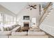 Bright living room with vaulted ceiling, fireplace, and staircase at 6119 Fairlong Nw Run, Acworth, GA 30101