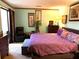 Bedroom with light green walls and slider to the back deck, neutral carpet and purple accents at 9400 Roberts Dr # 7M, Atlanta, GA 30350
