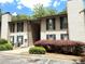 Charming two-story condo with green shutters and well-maintained landscaping at 9400 Roberts Dr # 7M, Atlanta, GA 30350
