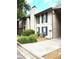 Exterior of home with beige siding, green shutters, and well-kept landscaping at 9400 Roberts Dr # 7M, Atlanta, GA 30350