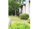 Exterior view of the property showcasing well-maintained landscaping and lawn at 9400 Roberts Dr # 7M, Atlanta, GA 30350