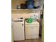 Small laundry room with washer and dryer and shelving for storage at 9400 Roberts Dr # 7M, Atlanta, GA 30350