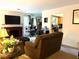 Relaxing living room featuring a cozy fireplace and open access to the kitchen at 9400 Roberts Dr # 7M, Atlanta, GA 30350