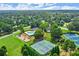 Beautiful aerial view of neighborhood amenities including a playground, pool, and tennis courts at 13090 Magnolia Crescent Dr, Roswell, GA 30075