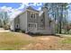 Backyard with grey siding, a large deck, and a well-manicured lawn at 13090 Magnolia Crescent Dr, Roswell, GA 30075