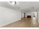 Finished basement area with laminated floors, recessed lighting and bonus room for entertainment at 13090 Magnolia Crescent Dr, Roswell, GA 30075