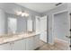 Bathroom featuring double sinks, granite countertops, and white cabinetry creating a bright and modern space at 13090 Magnolia Crescent Dr, Roswell, GA 30075