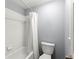 Practical bathroom with a white tiled shower-tub combination and classic design elements at 13090 Magnolia Crescent Dr, Roswell, GA 30075