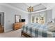Comfortable primary bedroom with natural light, soft colors, and ensuite bathroom at 13090 Magnolia Crescent Dr, Roswell, GA 30075