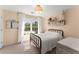 Cozy bedroom with large window, neutral color palette, and antique furnishings providing classic appeal at 13090 Magnolia Crescent Dr, Roswell, GA 30075