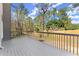 Spacious deck featuring wood flooring and wooden railings overlooking the backyard at 13090 Magnolia Crescent Dr, Roswell, GA 30075