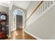 Bright foyer with hardwood floors and a staircase featuring white railings at 13090 Magnolia Crescent Dr, Roswell, GA 30075