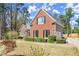 Charming brick home with a well-manicured lawn and mature landscaping, offering great curb appeal at 13090 Magnolia Crescent Dr, Roswell, GA 30075