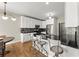 Bright kitchen featuring stainless steel appliances, bar seating, and a modern backsplash at 13090 Magnolia Crescent Dr, Roswell, GA 30075