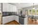 Bright kitchen featuring a center island with a sink, stainless steel appliances, and hardwood floors at 13090 Magnolia Crescent Dr, Roswell, GA 30075