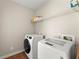 Clean laundry room featuring a modern washer and dryer for easy laundry access at 13090 Magnolia Crescent Dr, Roswell, GA 30075