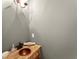 Rustic powder room featuring a copper vessel sink and unique details at 13090 Magnolia Crescent Dr, Roswell, GA 30075