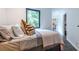 Cozy bedroom featuring hardwood floors, comfortable bed, and a window with natural light at 4052 Loch Highland Ne Pass, Roswell, GA 30075