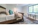 Bright bedroom featuring hardwood floors, a comfortable bed, and a window with a view of the trees at 4052 Loch Highland Ne Pass, Roswell, GA 30075
