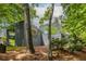 Striking architectural design of modern home nestled among mature trees on a lush lot at 4052 Loch Highland Ne Pass, Roswell, GA 30075