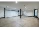 Large unfinished three car garage interior with high ceilings and white doors at 4052 Loch Highland Ne Pass, Roswell, GA 30075