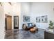 Well lit living room with soaring ceiling, stained concrete, designer lighting and modern decor at 4052 Loch Highland Ne Pass, Roswell, GA 30075