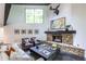 Cozy living room featuring a stone fireplace, modern decor, and a comfortable seating area at 4052 Loch Highland Ne Pass, Roswell, GA 30075