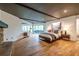 Bright main bedroom features hardwood floors, wood beam ceiling, and sliding glass doors to a private balcony at 4052 Loch Highland Ne Pass, Roswell, GA 30075