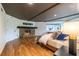 Main bedroom with stone fireplace, hardwood floors, and large windows for natural light at 4052 Loch Highland Ne Pass, Roswell, GA 30075