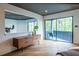 Bright main bedroom with hardwood floors and sliding glass doors to a private outdoor balcony at 4052 Loch Highland Ne Pass, Roswell, GA 30075