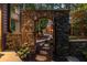 Picturesque outdoor space featuring a stone archway leading to an outdoor fireplace and seating area at 4052 Loch Highland Ne Pass, Roswell, GA 30075