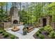 Secluded outdoor living area with a stone fireplace and custom seating at 4052 Loch Highland Ne Pass, Roswell, GA 30075