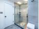 Modern shower with gray tile, glass door and rainfall showerhead at 4052 Loch Highland Ne Pass, Roswell, GA 30075