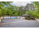 Community tennis courts with a gazebo are surrounded by mature trees and well-maintained landscaping at 4052 Loch Highland Ne Pass, Roswell, GA 30075